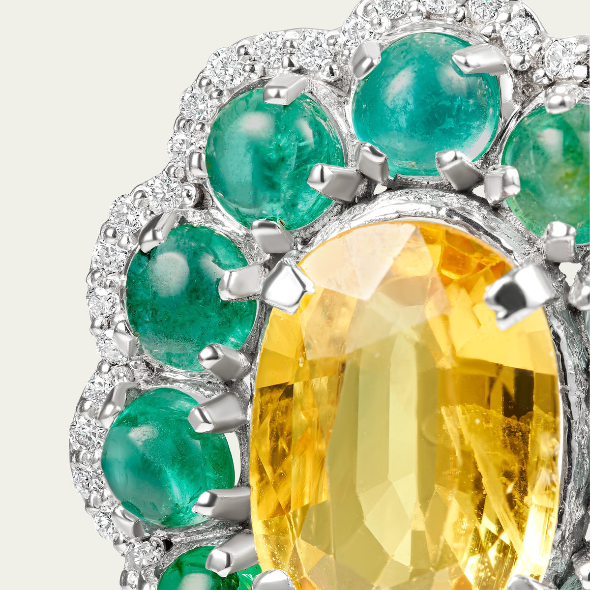 Close view of the Marigold Hero II Earrings in 18K white gold, emerald and yellow sapphire and diamond