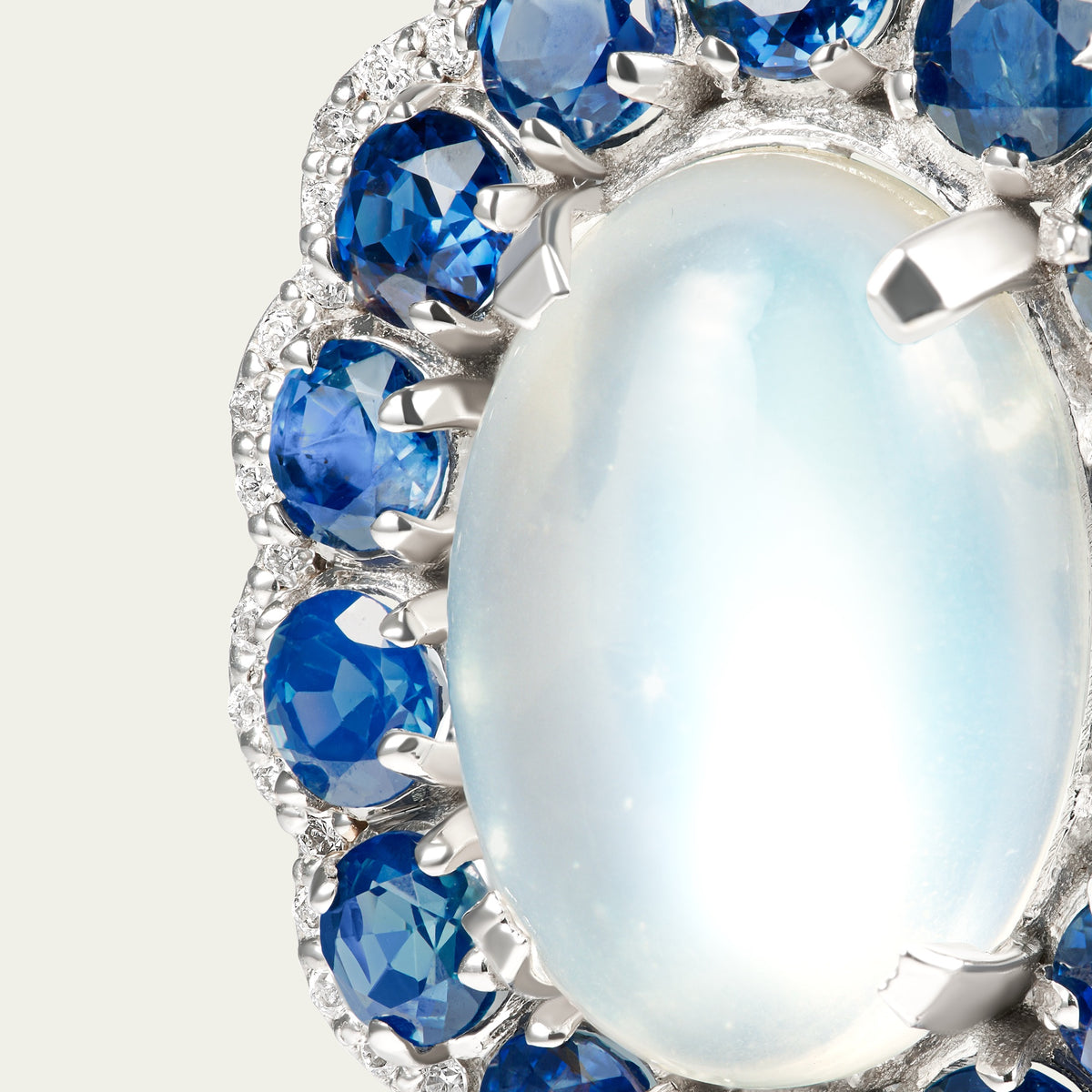 Close view of the Marigold Moon Earrings in 18K white gold, blue sapphire and moonstone and diamond