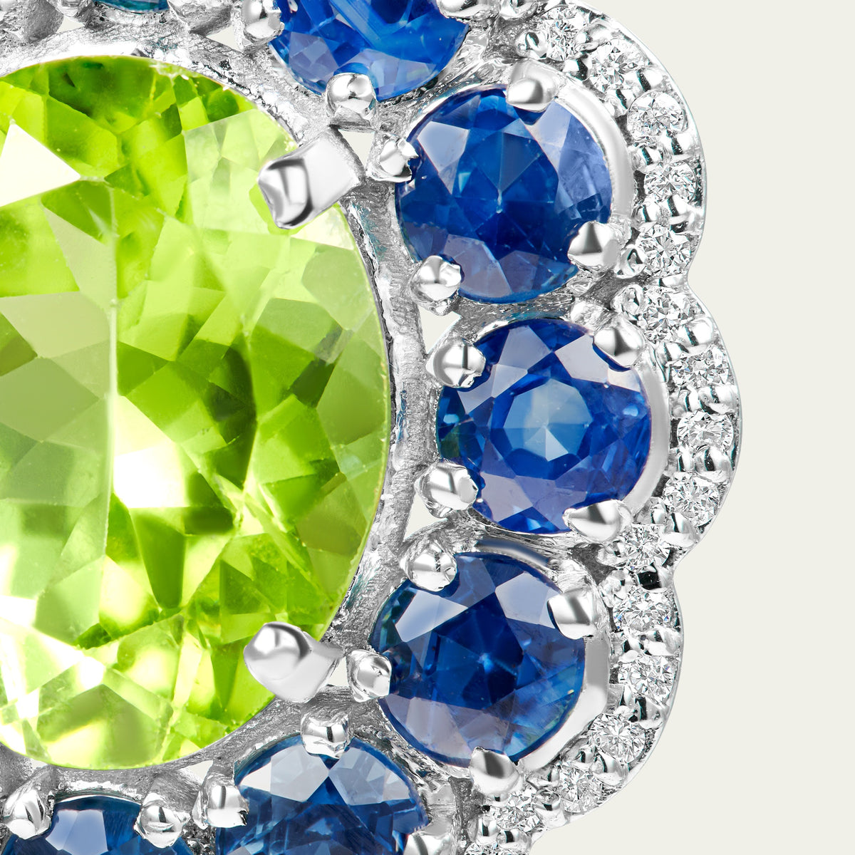 Close view of the Marigold Peri Earrings in 18K white gold, blue sapphire and peridot and diamond