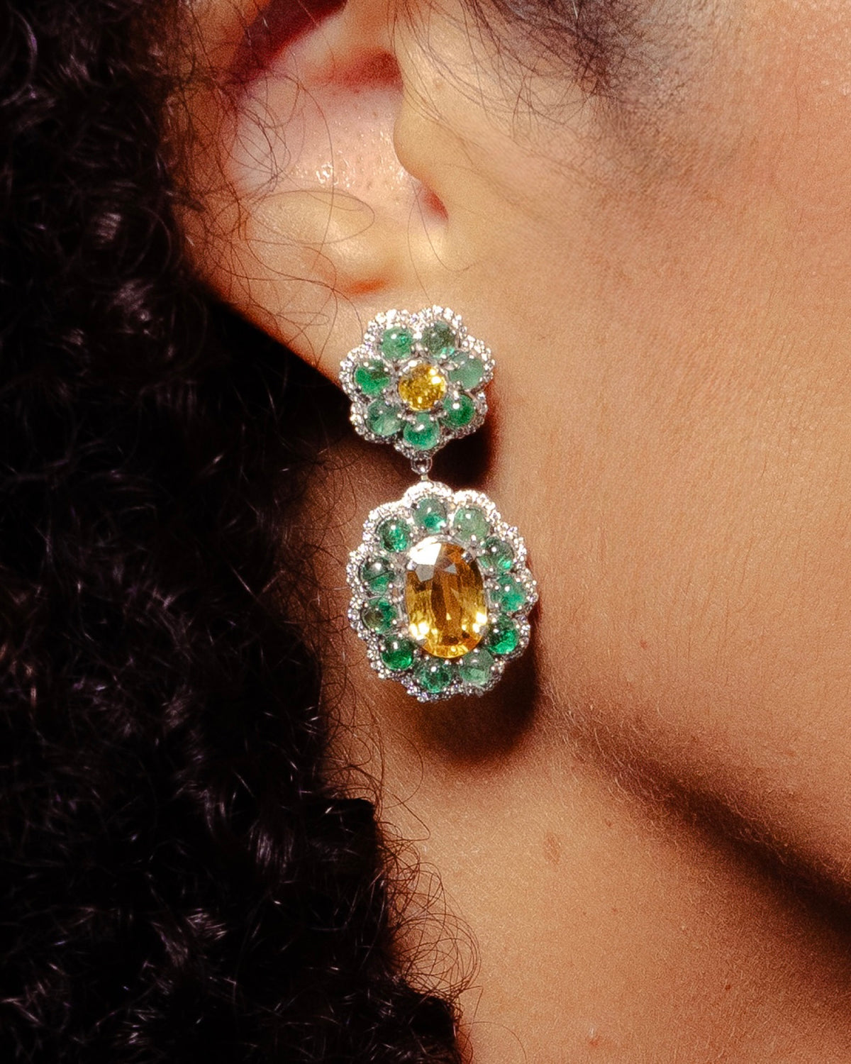 Close view of the Marigold Hero II Earrings in 18K white gold, emerald and yellow sapphire and diamond