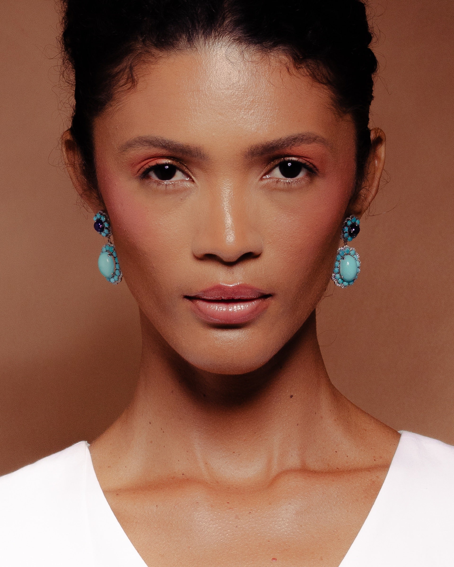 Model wearing cluster drop earrings
